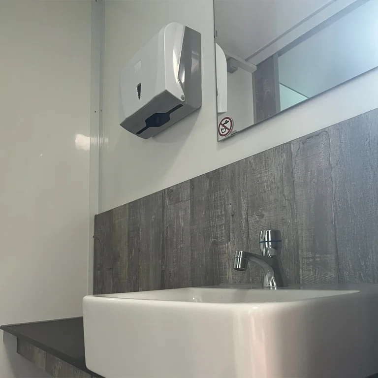 Rent a high-quality restroom trailer with modern sinks, large mirrors, and stylish faucets.
